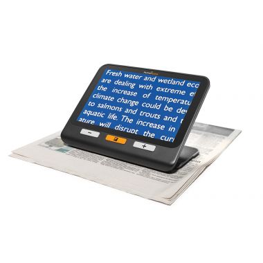 Image of exploré 8 on its built-in stand showing the white text on a blue background color contrast option to read a newspaper.
